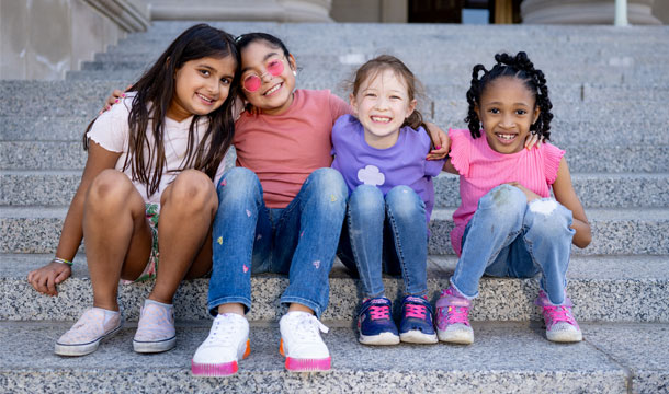 Girl Scouts sitting on steps. 